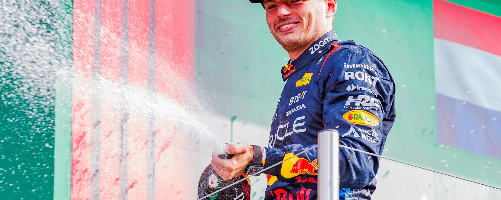 Verstappen spraying champagne on the podium